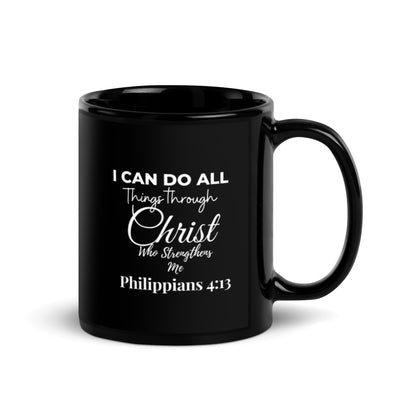 A black glossy ceramic mug with white text and design, featuring a quote and a Bible verse.